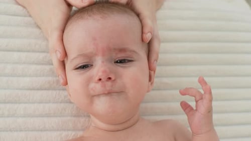 Closeup Top View of Infant Baby Being Manipulated By Unrecognizable Osteopathic Manual Therapist or