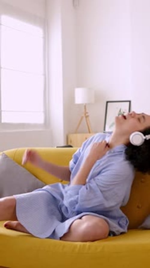 Woman Sings Along to Music on Headphones