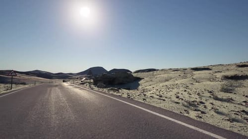 A Long Road Cuts Through Mongolias Sunlit Arid Landscape