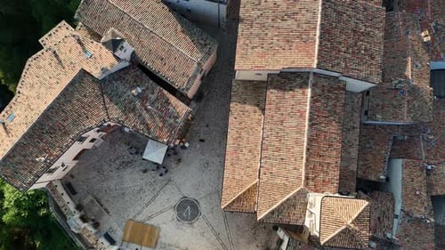 Die bezaubernden Dächer eines italienischen Dorfes umgeben einen malerischen Kopfsteinpflasterplatz voller Geschichte und