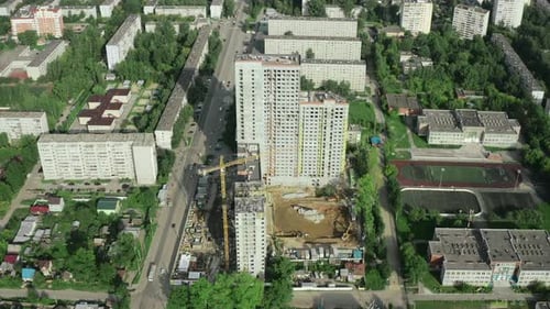 Residential complex under construction in city in summer. Stock footage. Districts of city