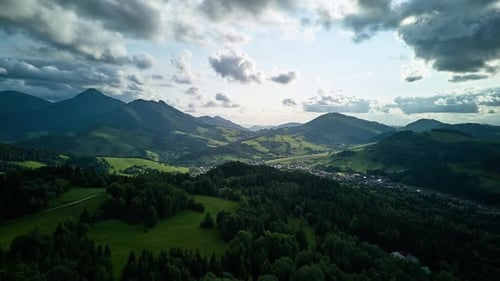 Aerial hyperlapse of idyllic hilly Carpathian landscape with forests and valleys in summer