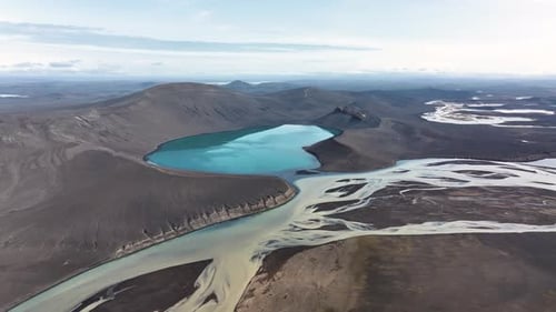 Iconic Skyggnisvatn lake in Iceland surrounded in volcano mountains at sunny day. Aerial wide shot.