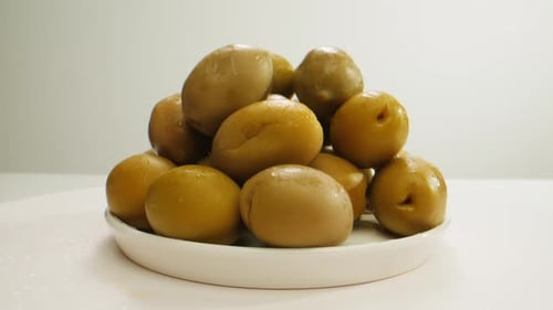 Aceitunas verdes redondas en escabeche de Grecia, primer plano de aceituna roja, negra y verde fermentada española