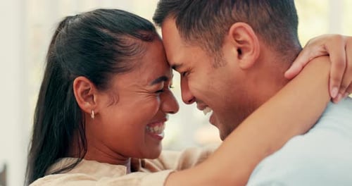 Young Couple Embracing Lovingly Indoors