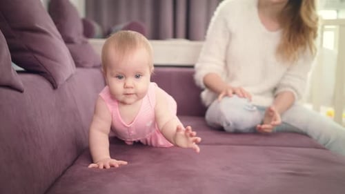 Little Baby Crawling on Home Sofa. Beautiful Child Crawling on Bed. Sweet