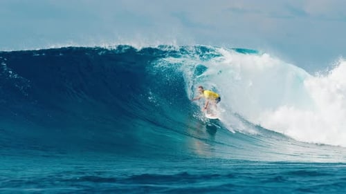Professional Surfer Rides Big Ocean Wave in the Maldives