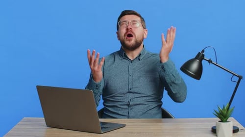 Man Reacts to Bad News on Laptop Computer