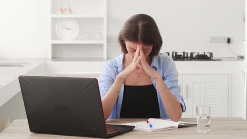 Thoughtful Young Caucasian Woman in Casual Clothes Working on Laptop Thinking on New Project While
