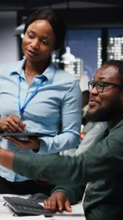 Vertical Video African American Workers Team Consulting Each Other in Solving Tasks at Night