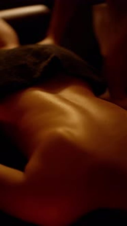 Woman Receives Massage in Dark Room