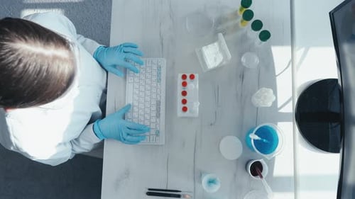 Scientist Typing on Keyboard in Laboratory Overhead