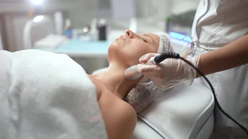 Caucasian Female Getting RF Neck Lifting Procedure
