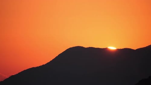 Setting Sun and Silhouette of the Mountain
