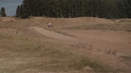 Dirt Bike Rider Jumping on a Rural Motocross Track