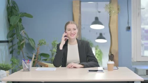 Businesswoman Talking on Phone in Office