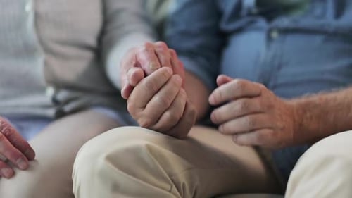 Senior Couple Holding Hands in Tender Moment
