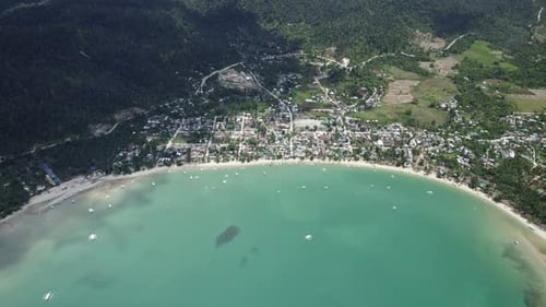 Turquoise Bay Boats and Small Town Off the Coast in Asia