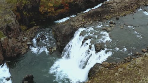 Aerial view of a small waterfall in wilderness. Drone view of a waterfalll in Iceland.