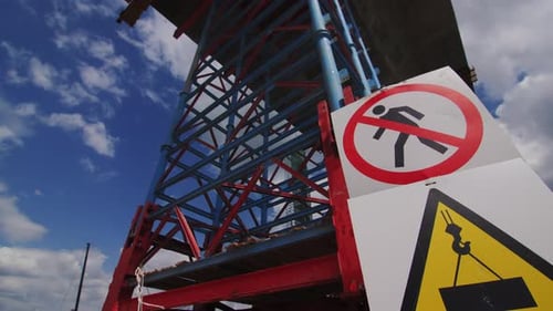 Warning Signs for Builders By Scaffolds Under Bridge