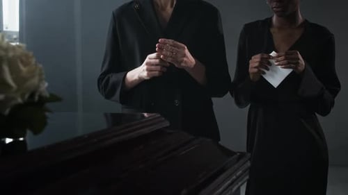 Mourning Women Attend Funeral with Coffin