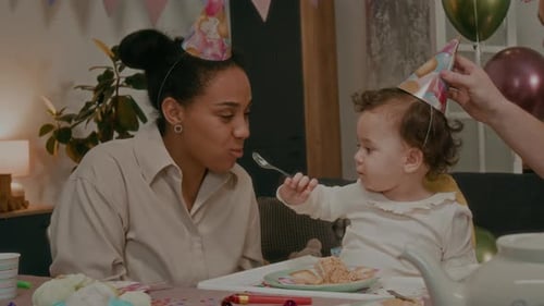Sweet Infant Feeds Mom Cake at Birthday Celebration