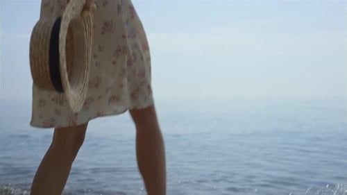 Joyful Barefoot Woman Splashing Ocean Water by Wet Legs Close Up. Unrecognizable