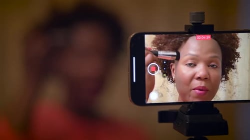 Woman Records Makeup Tutorial on Phone