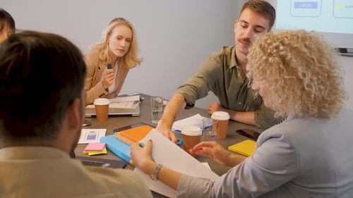 Team Meeting Around Table in Office Conference Room