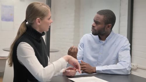 Man and Woman Having Serious Business Meeting