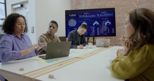 Business People Meeting and Discussing Presentation in Office