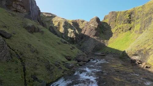 Aerial Drone View Of An Icelandic Canyon And River Surrounded By Mountains