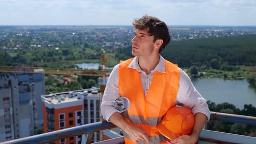 Architect Stands Overlooking City Construction Site