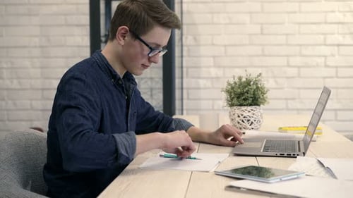 Teenage Boy Studying at Desk with Laptop