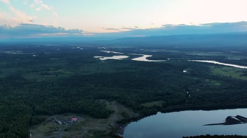 Aerial View of River Valley Forest and Distant Mountains Media