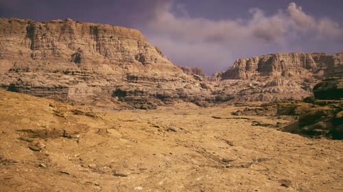 Vast Desert Landscape Showcasing Rugged Cliffs and Dramatic Geological Features
