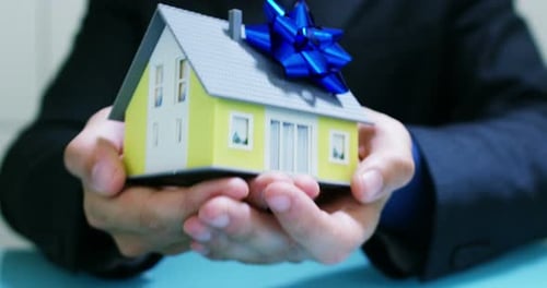 rent or purchase the house .the hands of an insurer or real estate agent showing a house with hou