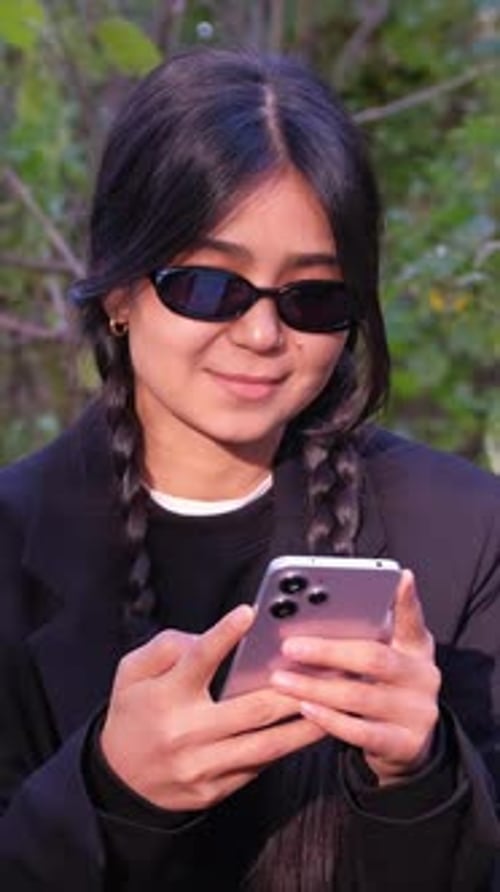 Teen with Braids Uses Mobile Phone Outside