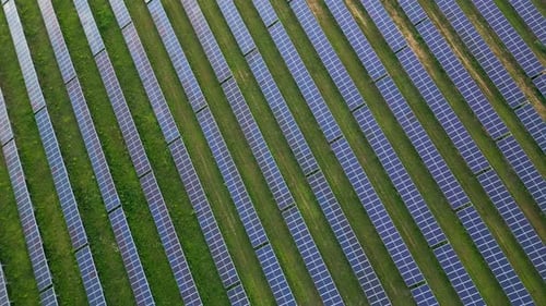 Big Solar Power Station on a Green Meadow Aerial View