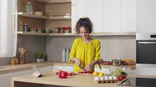 Smiling Woman Prepares Salad in Modern Kitchen