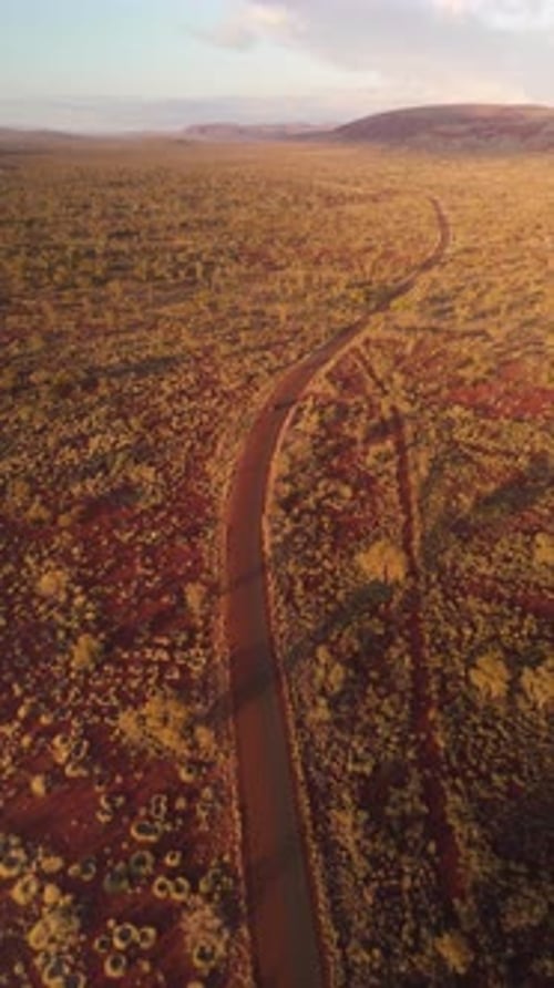 Aerial view of desert landscape and winding road, Australia.