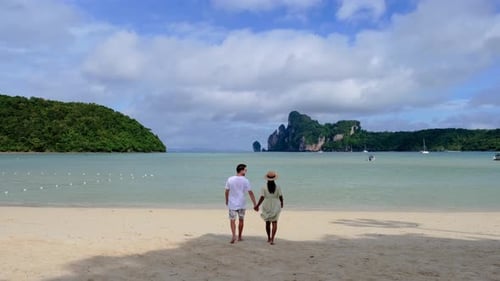 A Couple of Men and Woman Walking on the Beach of Koh Phi Phi Thailand