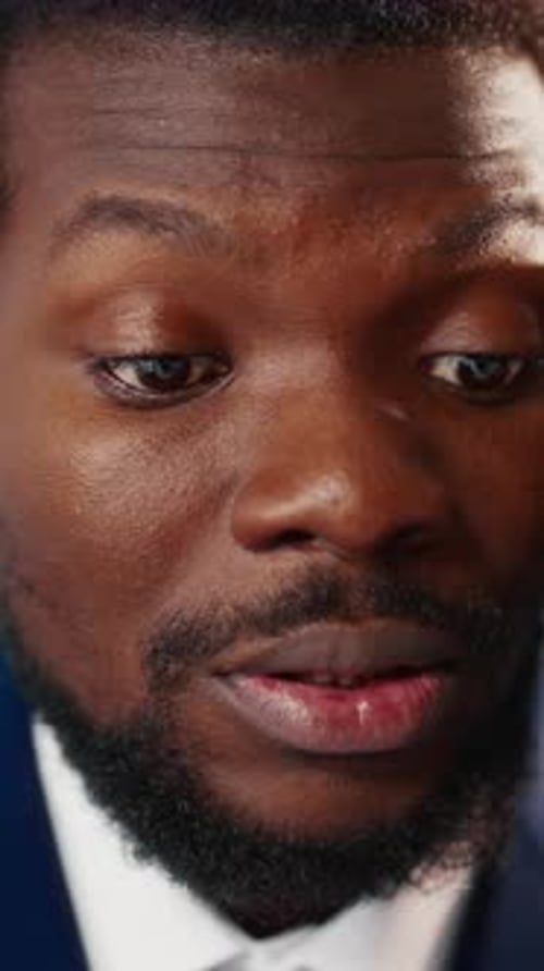 Closeup Portrait of Emotional Black Businessman or Stock Broker Talking By Phone in Office African