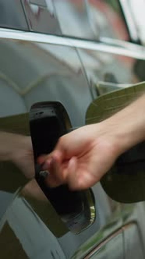 Vertical Video Close Up of Driver Opening EV Car Charging Port Flap Attaching Electric Cable