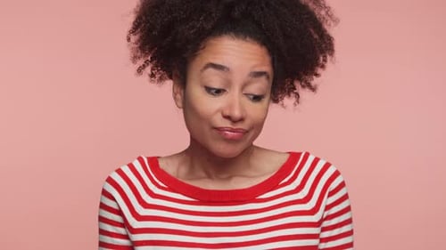 Woman Tilting Head Making Funny Faces in Studio