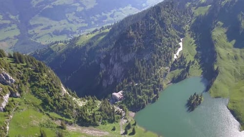 Flying over lake in Top of mountains in Switzerland 4k