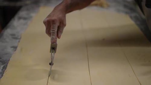 wheel cutter, artisan bakery, baker making bread and pastry, dough kneading