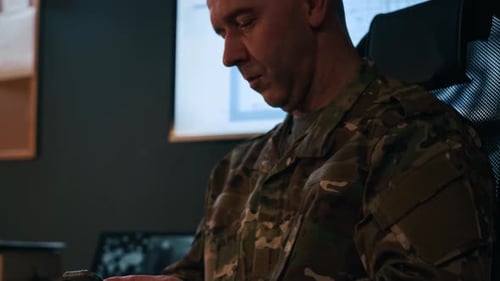 Adult Commander Using Phone at Workplace in Military Office