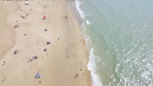 Mediterranean beach during summer with people in the water