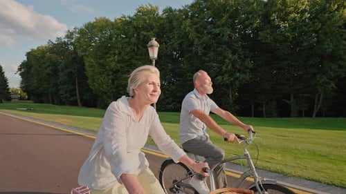 Elderly Couple Biking Together in Park